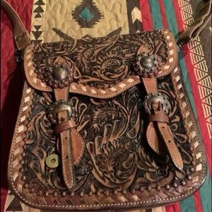 Tooled leather conceal carry tote. Lots of room, couple of scratches on the back